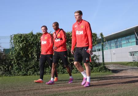 Wayne Rooney, Ashley Young, and James Wilson of Manchester United at a training session.