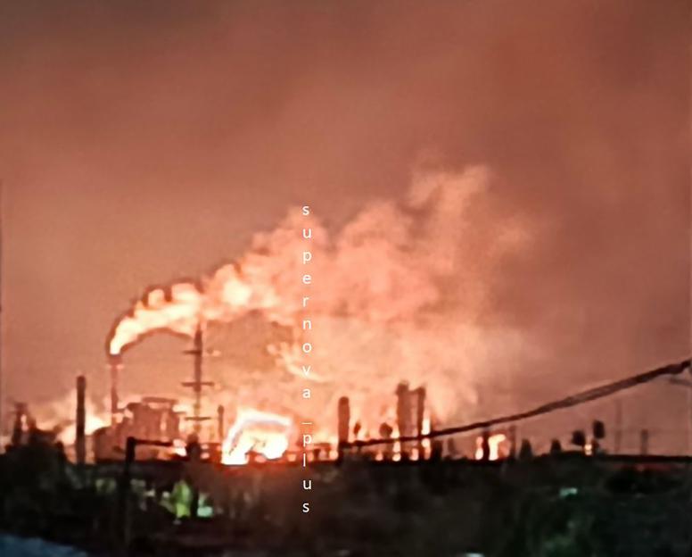 Burning oil refinery.
