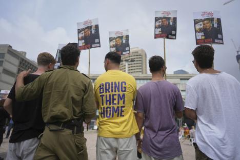 Israelis holding signs demanding the release of hostages.