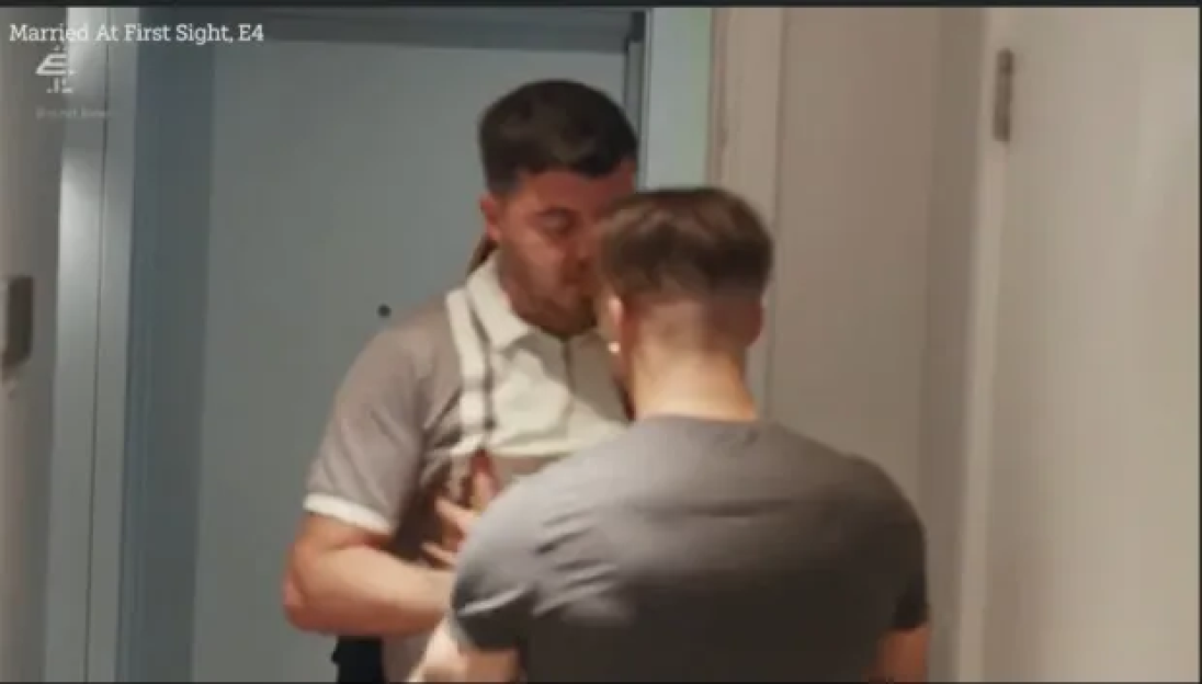Luke Worley in a grey polo shirt with white suspenders facing Jordan Gayle in a grey t-shirt.