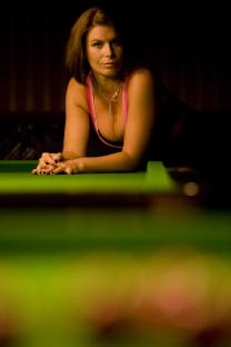 Snooker referee Michaela Tabb posing at a snooker table.
