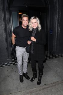 Donna Mills and a male companion leaving a restaurant.