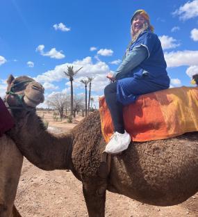 Woman riding a camel in Marrakesh.
