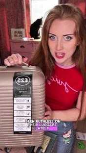 Woman showing a Primark cabin bag.