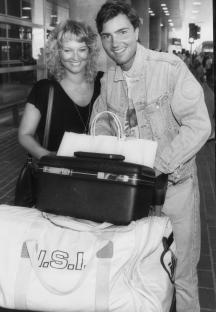Black and white photo of Nick Berry and Gillian Taylforth at an airport.