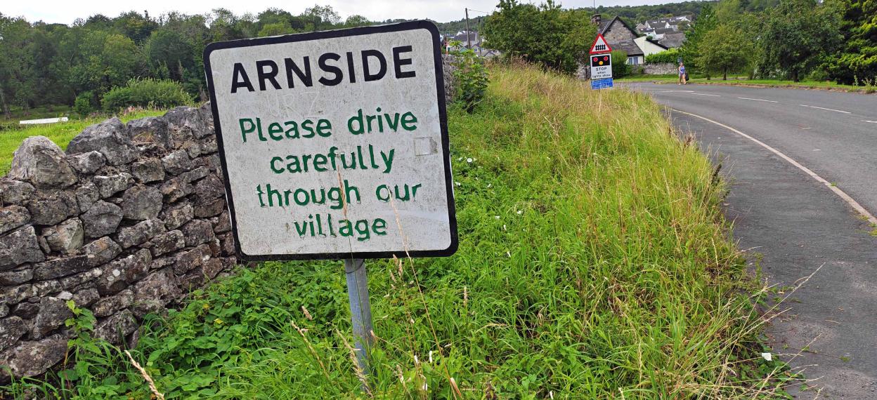 Arnside village sign: Please drive carefully through our village.