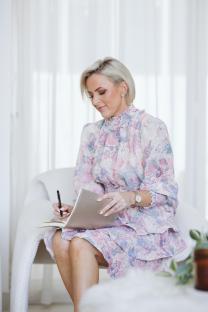Woman writing in a notebook.