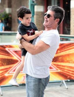 Simon Cowell holding his son Eric.