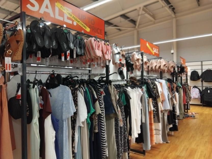Asda sale racks with clothing and shoes.