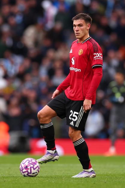 Manuel Ugarte of Manchester United on the field during a Premier League match.