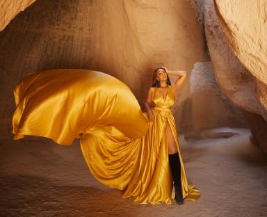 Osas Ighodaro Rocks Cappadocia’s Fairy Chimneys in a Bold Gold Dress | See Photos
