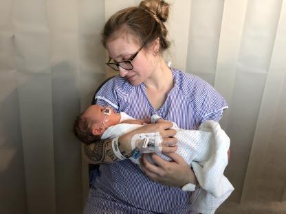 Gabi Simpson holding her newborn daughter Bea.