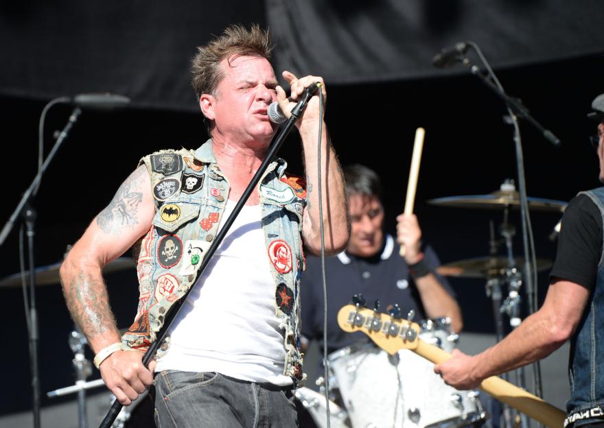 Singer David Roach of Junkyard performing at a concert.