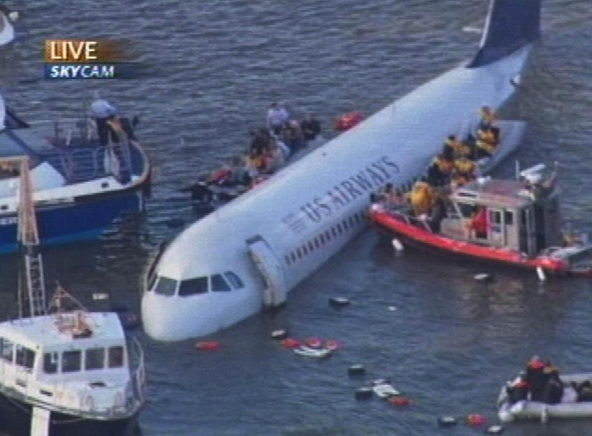 US Airways aircraft in the Hudson River with passengers being rescued by boats.