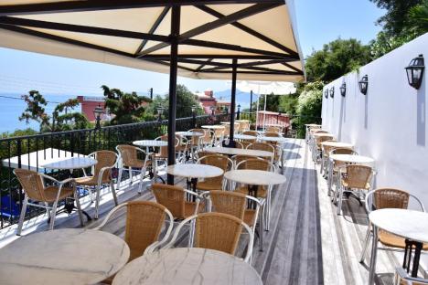 Outdoor patio seating area with ocean view.