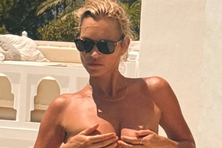 Kate Moss covers her naked chest while swimming on holiday in Ibiza