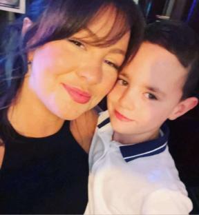 Woman and young boy posing for a photo.