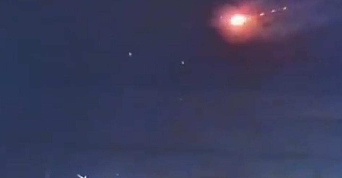 Nighttime video of a bright object exploding in the sky.