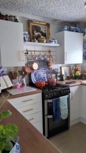 Renovated kitchen with blue and white china and copper cookware.