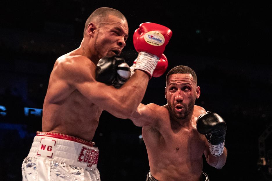 Chris Eubank Jr. (white shorts) and James DeGale (black shorts) trade punches during their IBO World Super Middleweight Title fight.