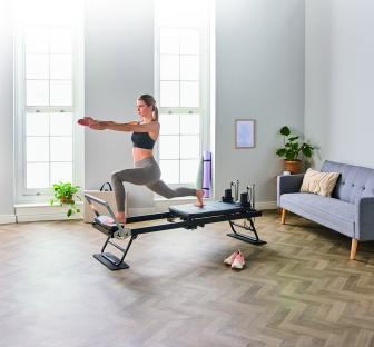 Woman doing Pilates on a reformer.
