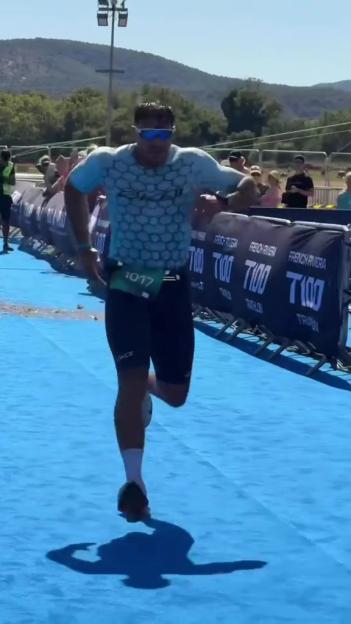 Tommy Fury finishing a triathlon.