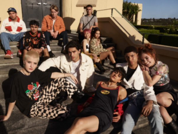 A group of young people posing on steps.