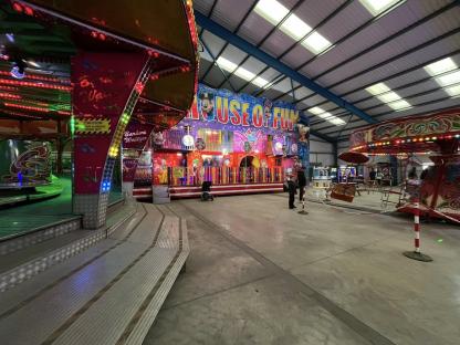 Interior view of Dingles Fun Park's House of Fun, showing various carnival rides.