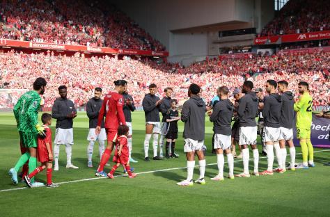 Liverpool and Arsenal players exchanging a guard of honor.