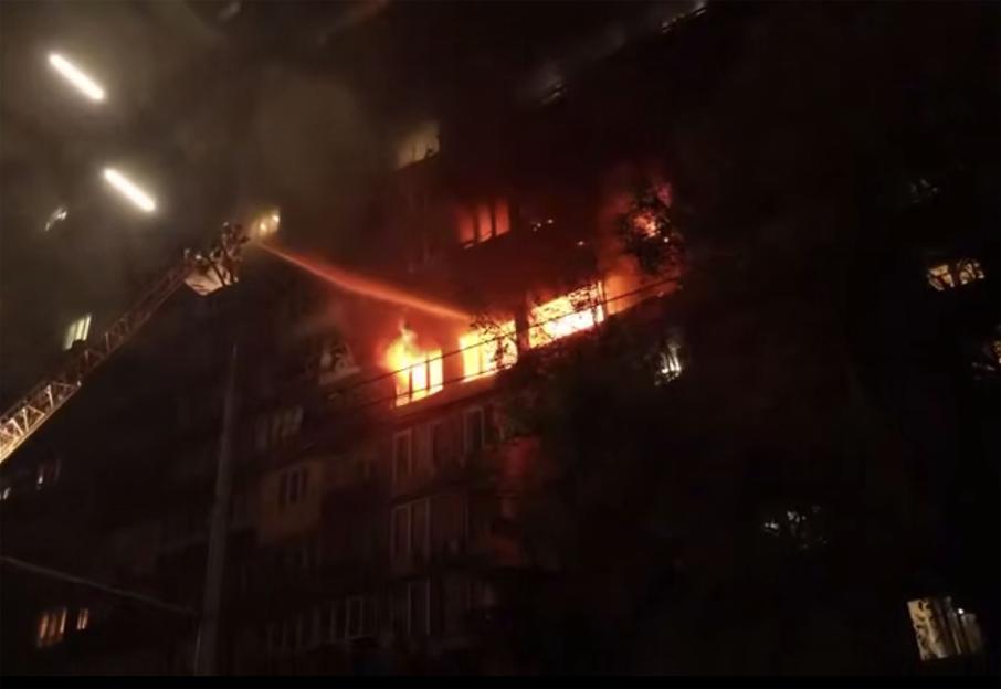 Firefighters extinguishing a burning building.