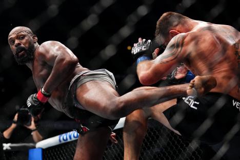 Mixed martial arts fighters Jon Jones and an opponent during a match.