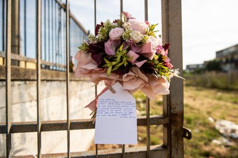 Memorial flowers and a note at a murder scene.