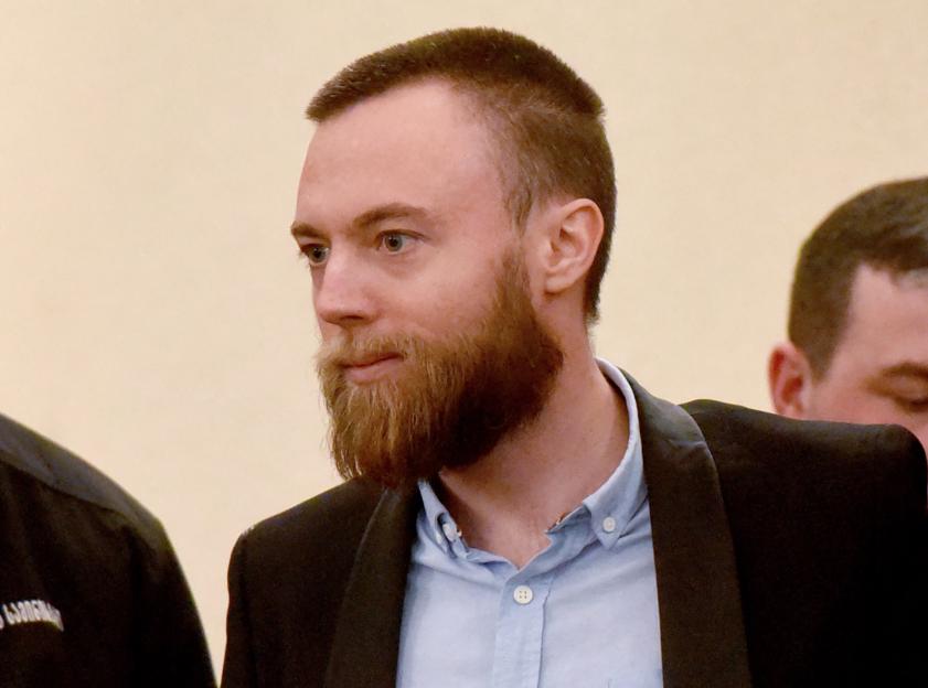 British citizen Jack Shepherd is escorted toward a defendants' cage.
