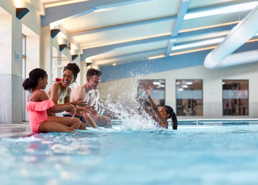 Family splashing in a resort pool.