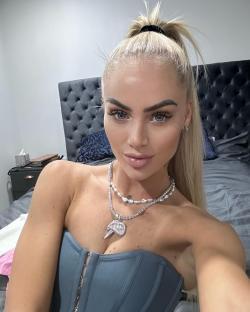 Alisha Lehmann wearing a teal corset top and necklaces.