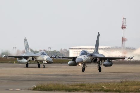 Two Taiwanese air force fighter jets taxiing on a runway.
