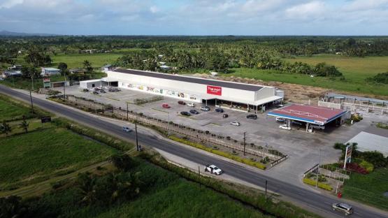 Aerial view of a True Mart supermarket and gas station in Navua, Fiji.