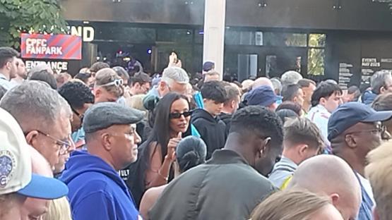 Maya Jama in a crowd of people.