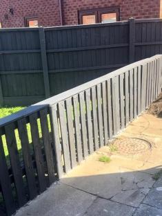 DIY pallet fence keeping dogs off grass.