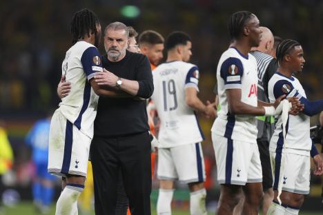 Ange Postecoglou, Tottenham's head coach, celebrates with players.
