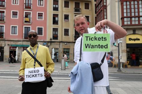 Two people holding signs that say