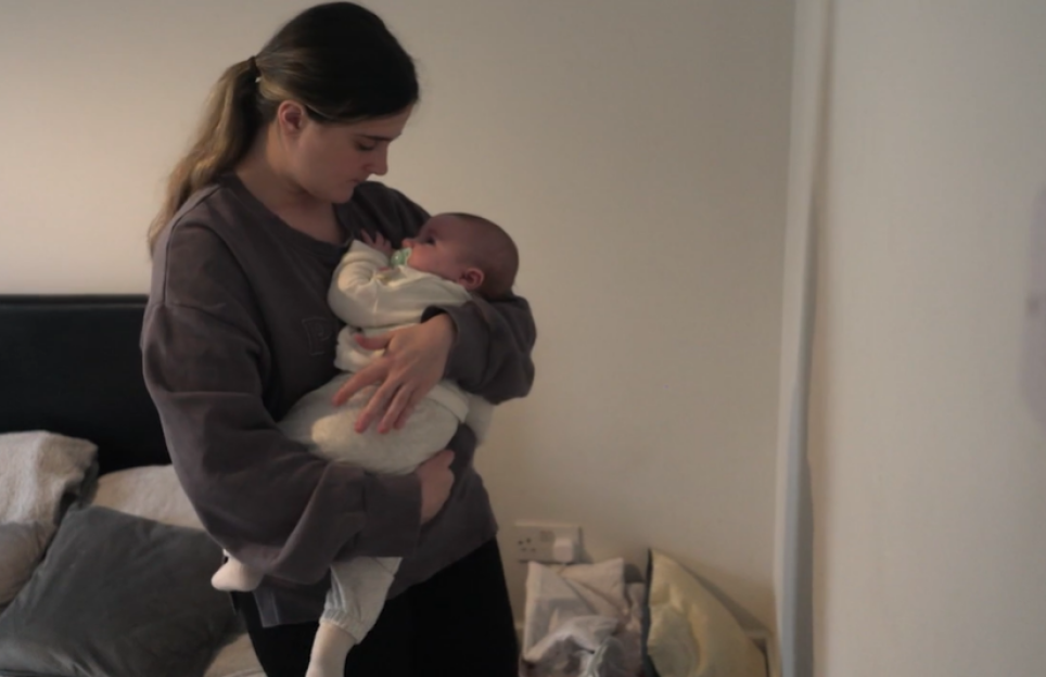 Woman holding a baby.