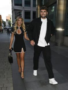 Molly Smith and Tom Clare, Love Island winners, holding hands.