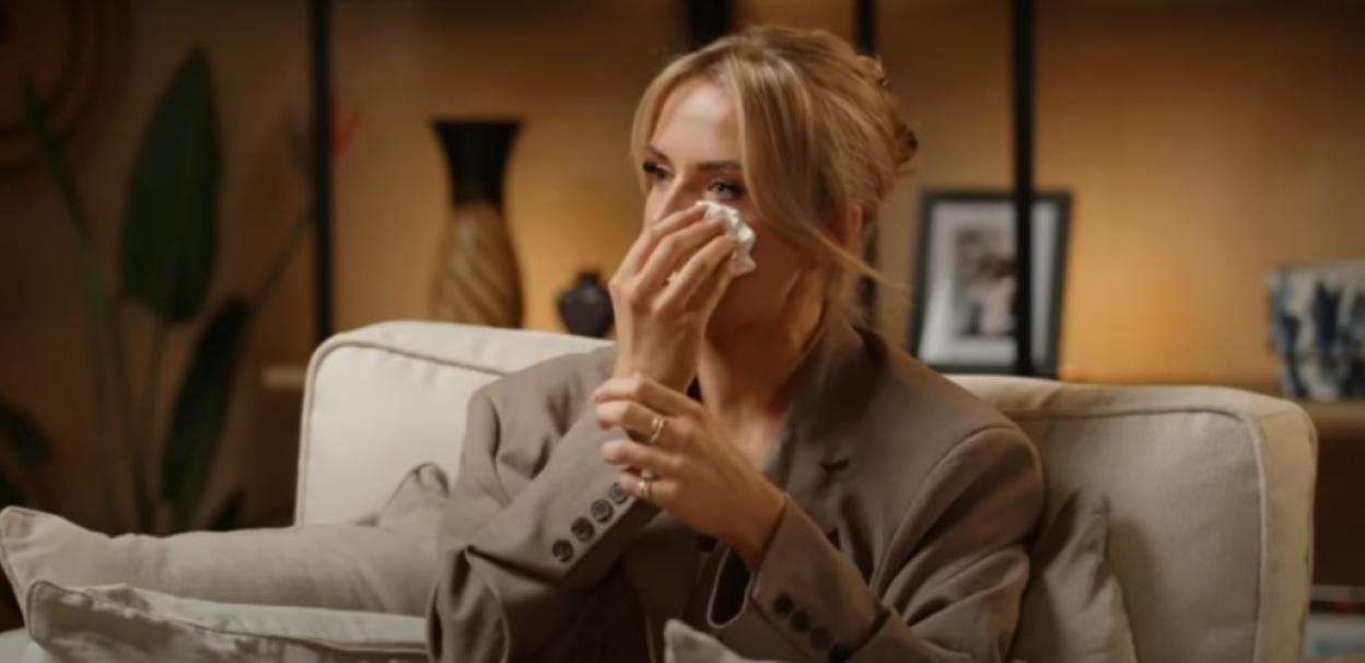 Faye Winter crying on a couch.