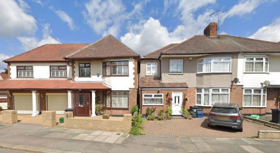 Two houses separated by a narrow gap.