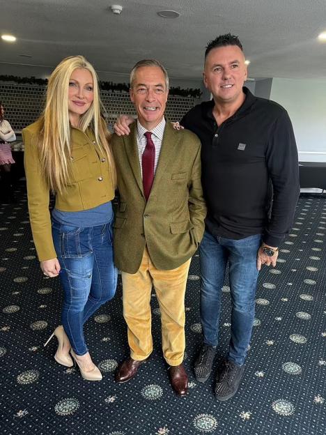 Nigel Farage, Caprice Bourret, and an unidentified man posing for a photo.