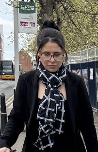 Woman wearing glasses and a black and white scarf.