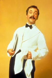 Andrew Sachs as a waiter in Fawlty Towers.