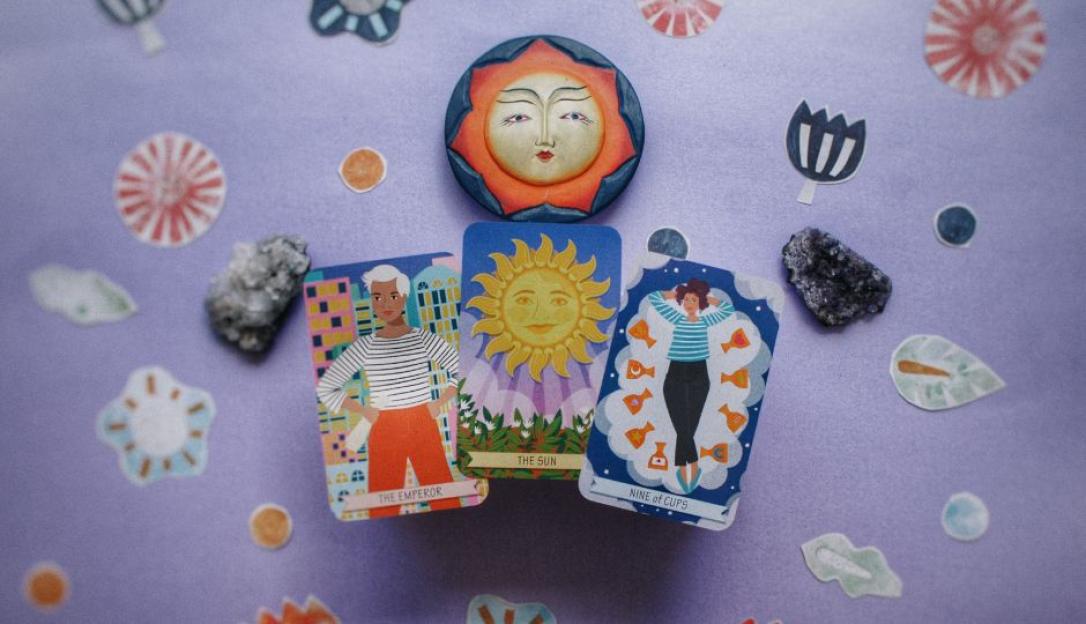Illustration of three tarot cards, The Emperor, The Sun, and Nine of Cups, arranged with a sun-shaped object and decorative elements.