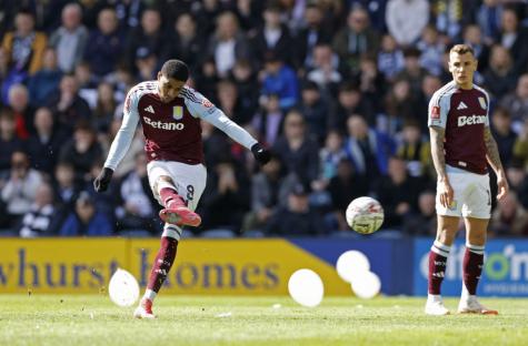 Aston Villa player taking a free kick.